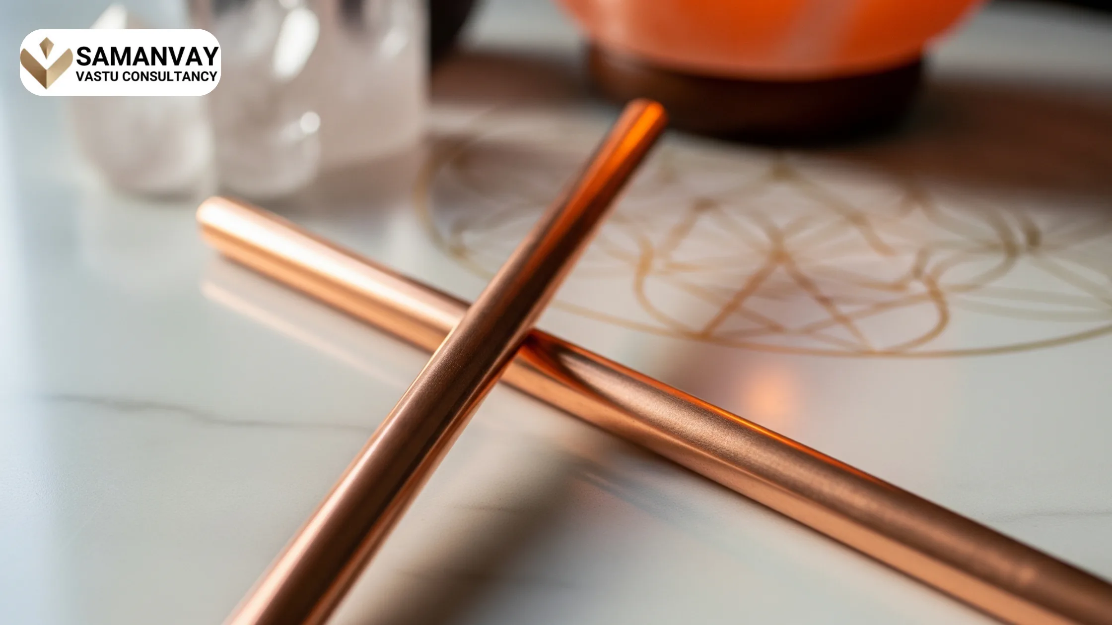 Close-up of copper rods used in Vastu energy healing, placed on a sacred geometric surface with crystals and a salt lamp in the background.